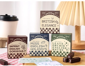 Retro English letter stamp sets in four vintage colors on a wooden tray with decor