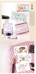 Detail view of aesthetic DIY scrapbooking stickers and decorative cards on a desk