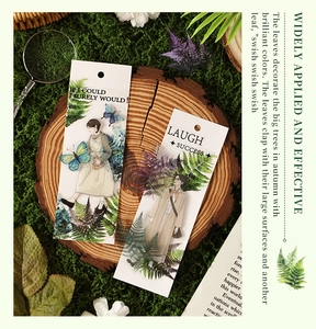 Close-up of vintage forest PET stickers with botanicals and figures on wood and moss