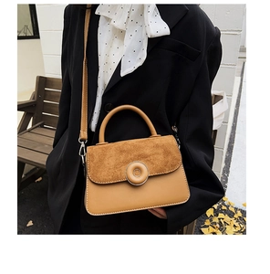 Detail of khaki frosted leather拼接handbag with circular metal lock and Ginkgo leaves