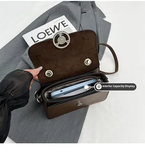 Interior view of small square bag showing spacious main compartment with a smartphone