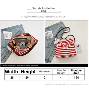 Size chart and interior view of striped canvas tote bag with brown shoulder strap