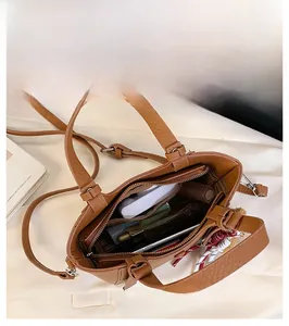 Detailed interior of the brown pebbled leather handbag showing the large capacity