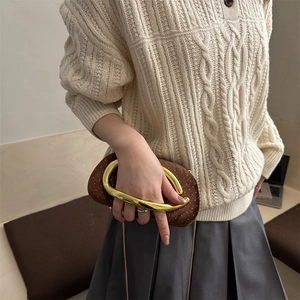Brown velvet evening clutch with gold horseshoe handle and sparkling metallic dots