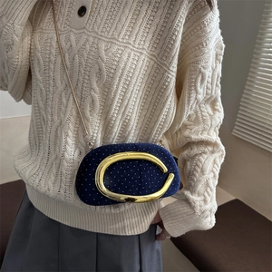 Blue velvet clutch bag with gold C-clasp and rhinestone accents, shown with chain strap