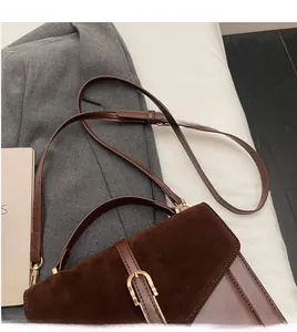 Detail showing high-quality suede and leather stitching with a golden horseshoe buckle
