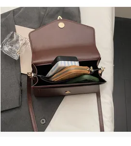Top view of brown PU leather crossbody bag interior showing spacious multi-layer compartments
