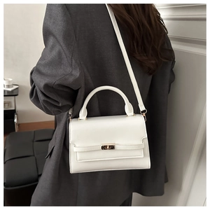 Detailed back view of a white rectangular crossbody bag with gold lock on a female model