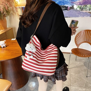 Striped canvas tote bag in red and white with brown leather strap and cloud charm