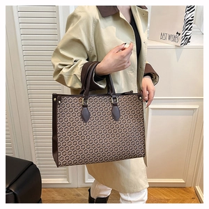 Close-up of vintage honeycomb pattern on a large brown leather tote bag for women