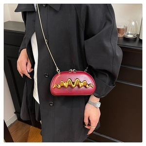 Close-up of wine red wave pattern clutch featuring gold chain and dual zipper detail
