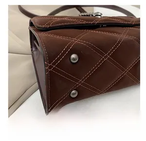 Vue détaillée du fond du sac en cuir matelassé avec clous en métal et coutures