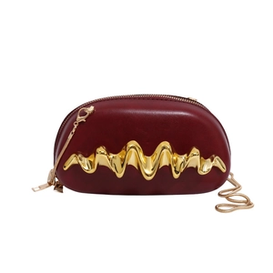 Fashionable burgundy leather box clutch bag with artistic gold wavy metal decoration