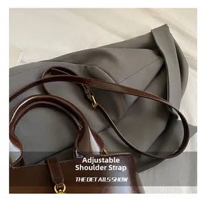 Detail of adjustable shoulder strap and gold hardware on retro brown leather bucket bag