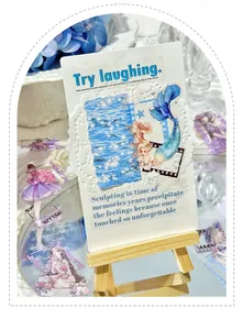 Detail of girl theme scrapbooking kit with mermaid illustration and die-cut cards