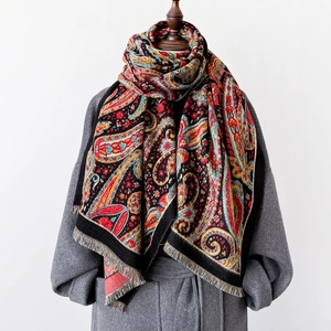 Elegant vintage paisley printed scarf with fringe detail on a female mannequin torso