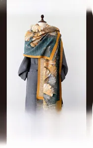 Detail of oil painting style thick scarf showing ginkgo leaf pattern and tassels