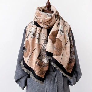 Elegant floral thick scarf with fringe in beige and coffee on a grey wool coat