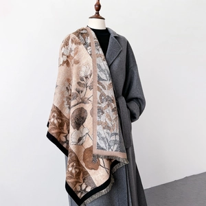 Elegant thick floral print shawl with fringe details draped over a gray wool coat