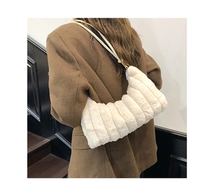 Detailed back view of a white plush tote bag featuring vertical quilted texture on a model