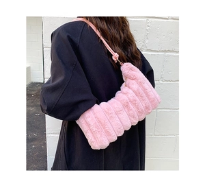 Pink plush underarm bag with horizontal quilting shown on a dark coat for contrast