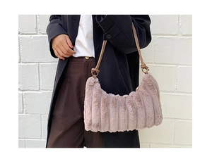 Detailed texture of dusty pink plush shoulder bag with vertical corduroy stripes