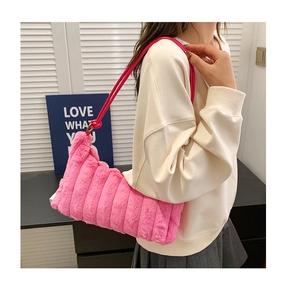 Detail of hot pink faux fur tote bag showing vertical quilted texture and shoulder strap