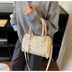 Chic cream white motorcycle style handbag with rivet details and long tassel zippers