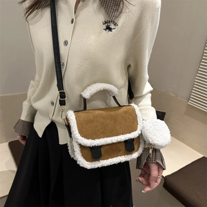 Suede saddle bag with shearling trim featuring a round coin purse and crossbody strap
