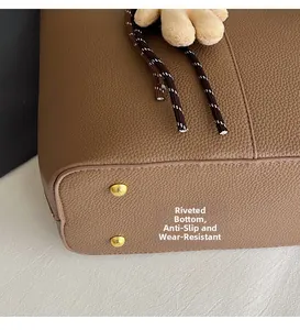 Detail of leather tote bag with protective bottom rivets and fine stitching craftsmanship