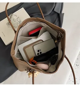 Detailed interior of brown leather tote showing spacious compartments and storage
