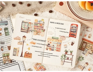 Close-up of cozy watercolor daily life stickers on notebook with cafe and shop themes