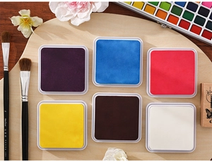 Detailed close-up of six-color eco-friendly square ink pads for vintage scrapbooking