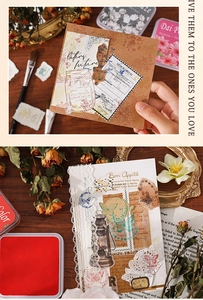 Close-up of vintage scrapbook kit with stamp pads and retro botanical stickers on wood