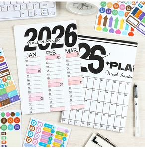 Detail of 2026 wall calendar planner with colorful functional habit tracker stickers