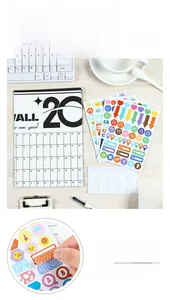 Close-up of 2026 planner with colorful functional stickers on a wooden desk setup