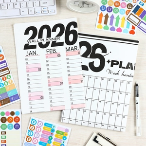 2026 minimalist wall calendar planner with motivational slogans on a modern office desk