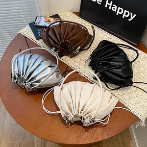 Pleated leather bucket bags in brown, black, silver, and white with drawstring handles