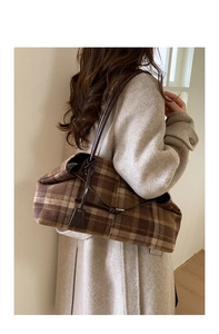 Close-up of vintage brown plaid wool tote bag showing texture and slim shoulder strap