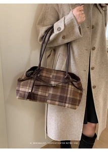 Detail of retro plaid wool tote bag with leather straps and minimalist drawstring closure