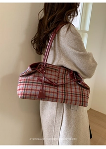 Model wearing a large vintage plaid tote bag with red patent leather straps and charms