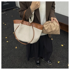 Detail of canvas and leather patchwork tote bag set with drawstring pouch insert