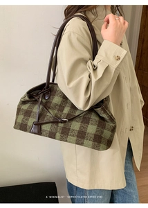 Retro plaid tote bag with brown leather straps and wool texture worn by a model