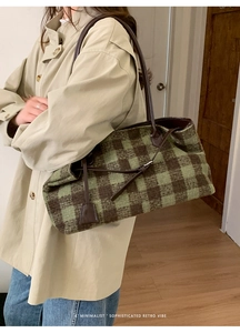 Detail of vintage green plaid wool tote bag showing large capacity and leather straps
