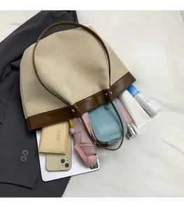 Detailed top view of large capacity beige tote bag showing spacious interior and items