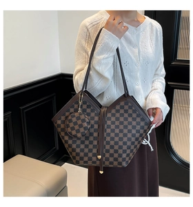 Detail of checkered bucket bag with detachable round coin purse and gold metal rivets