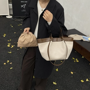Minimalist canvas and leather patchwork tote bag with drawstring inner pouch in autumn setting