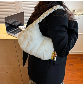 Gros plan du sac en peluche blanc avec poignée tressée et charm perlé de style ethnique