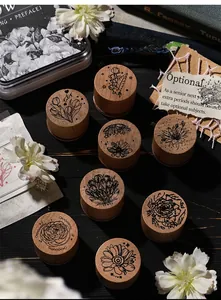 Detail view of 8 vintage wooden stamps with botanical floral patterns on a dark wood background