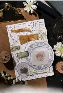 Detailed close-up of vintage celestial and floral wooden stamps with lace paper on clipboard